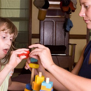 woman working with child on motor skills