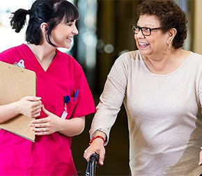 medical professional walks in hallway with patient