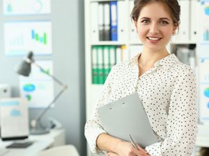 professional in office holding folder