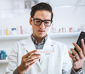 male pharmacist receiving prescription to fill