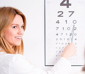 woman pointing at row on eye chart