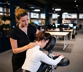 woman gives chair massage to client
