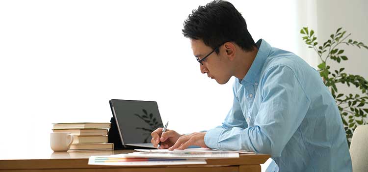 profile of man studying massage classes on laptop