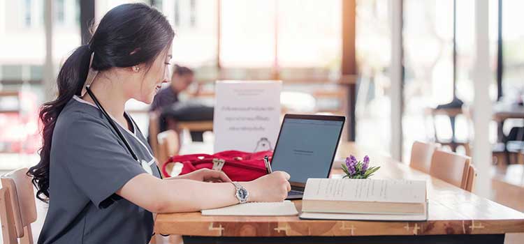 woman researching educational programs on laptop