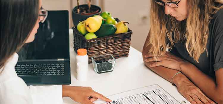 two women discussing nutrition education program at table