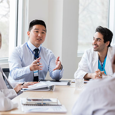 medical professionals in discussion at conference table