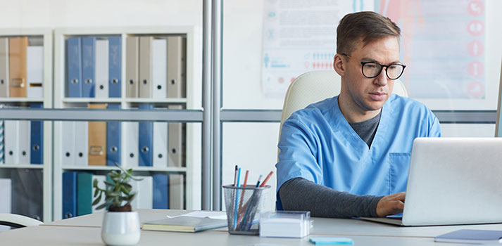 health technician working on laptop