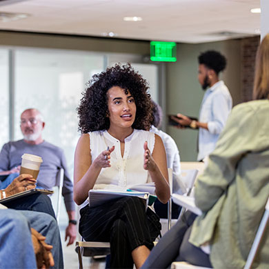 professional leading seated group in discussion