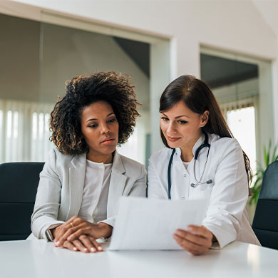 medical professional consults with business professional