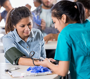 medical professional checking patients blood pressure