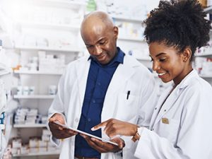pharmacist and technician looking at prescription order