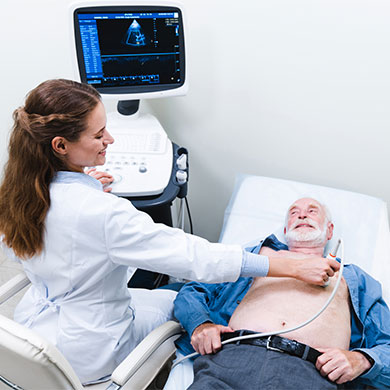 older patient receiving cardiac sonogram from sonographer