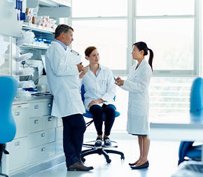 lab coat technicians meet in medical facility