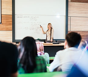 instructor at whiteboard in lecture hall