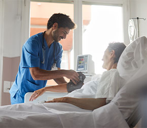 nursing assistant takes patient blood pressure