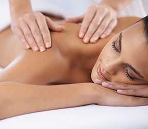 woman having shoulder massaged