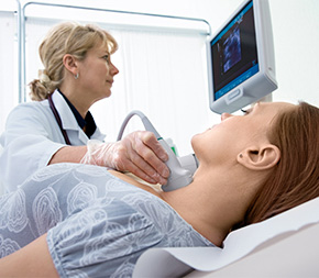 technician sonographs patient throat
