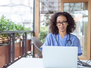 nurse doing course research on laptop