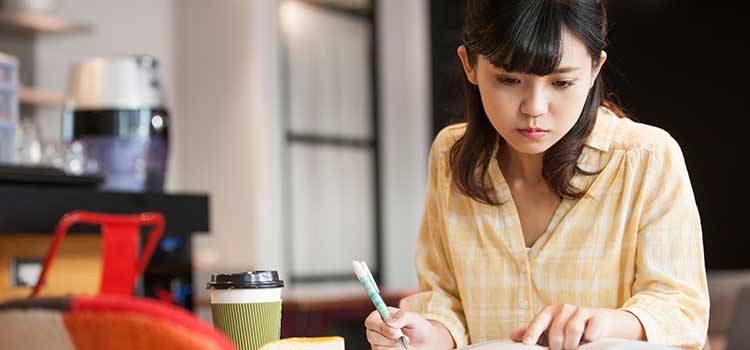 woman at desck taking certification course online