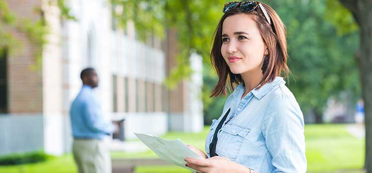 woman on college campus considering programs