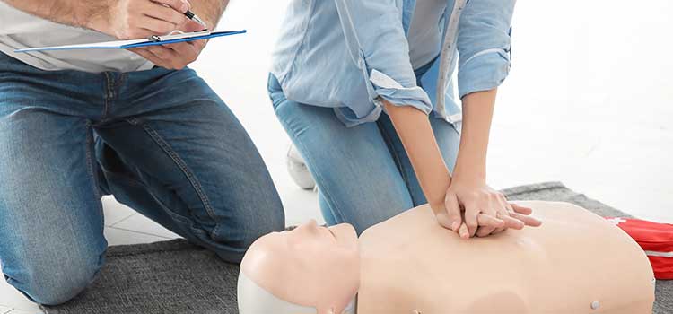 eoman being evaluated by instructor on CPR techniques