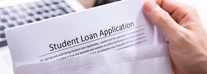 hand putting loan application into envelope