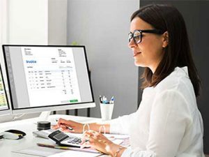 medical coder works at a computer and completes clinical documentation