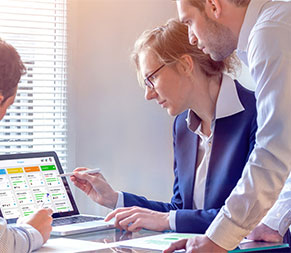healthcare administrators look over agile scrum board to provide lean management
