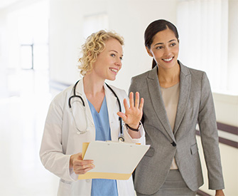 physician explains procedure to hospital administrator