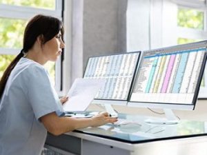 medical biller and coder reviews insurance claims and enters codes into computer