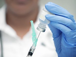 medical assistant prepping a shot