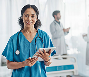 medical assistant holds tablet with patient data