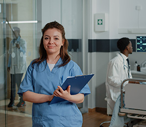 medical assistant removes patient chart after visit to hospital room
