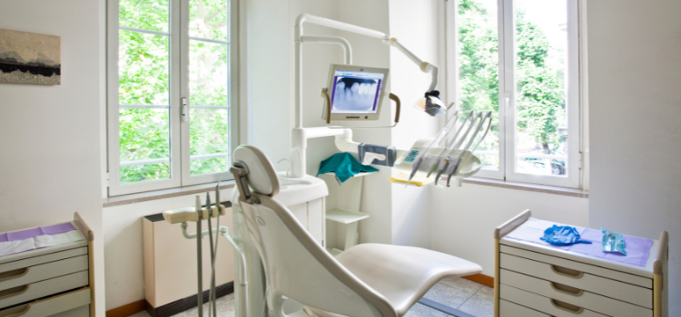 bright and empty dental office with exam chair, instruments and computer monitor